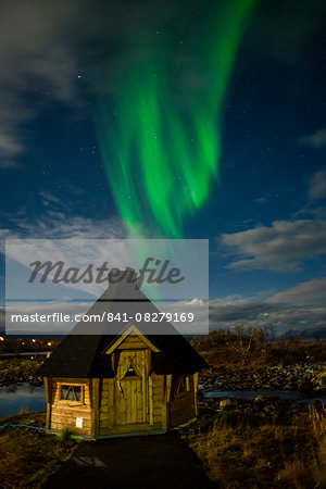 Aurora borealis over lakeside Kota (hut), Kilpisjarvi, Northwest Finland, Lapland, Finland, Scandinavia, Europe