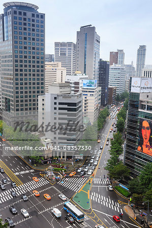 Elevated view of a busy city centre street and high rise buildings on a rainy summer day, City Hall area, Seoul, South Korea, Asia