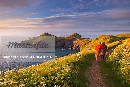 Walkers on the South West Coast Path on Pentire Head, overlooking The Rumps, Cornwall, England, United Kingdom, Europe