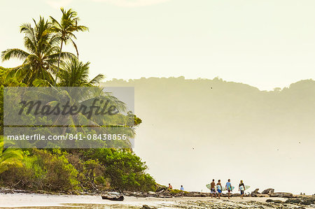 Surfers strolling on the beach at this hip southern Nicoya Peninsula surf resort, Santa Teresa, Puntarenas, Costa Rica, Central America
