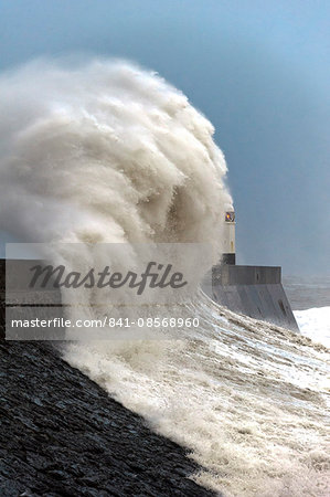 Huge waves crash against the harbour wall at Porthcawl, Bridgend, Wales, United Kingdom, Europe