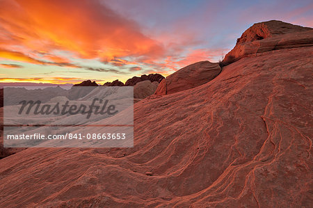 Brilliant orange clouds at sunrise over sandstone, Valley Of Fire State Park, Nevada, United States of America, North America Brilliant orange clouds at sunrise over sandstone, Valley Of Fire State Park, Nevada, United States of America, North America
