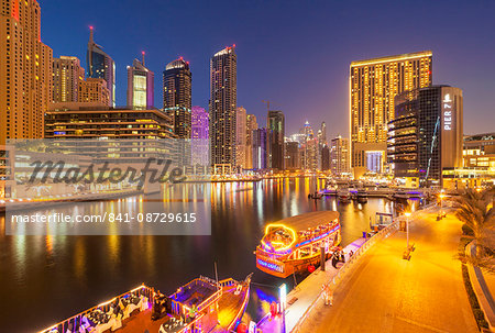 Dubai Marina skyline and tourist boats at night, Dubai City, United Arab Emirates, Middle East