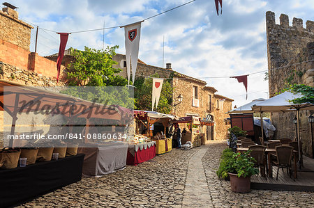 Gorgeous medieval village, market on cobblestone street with flags, Peratallada, Baix Emporda, Girona, Catalonia, Spain, Europe