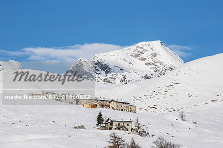 The snowy huts frame Peak Tambo in the background, Andossi, Spluga Valley, Province of Sondrio, Valtellina, Lombardy, Italy, Europe