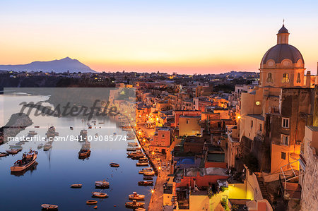 Marina Corricella, blue hour after sunset, fishing village, colourful houses, boats and church, Procida, Bay of Naples, Campania, Italy, Europe