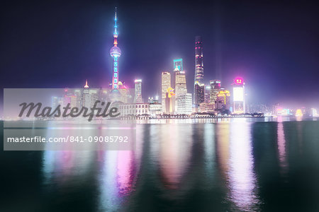 Foggy yet colorful skyline of Shanghai Pudong at night, Shanghai, China, Asia