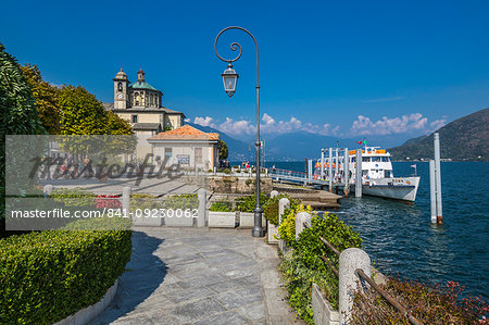 Cruiseboat moored near harbour and Santuario della SS Pieta Church in Cannobio, Lake Maggiore, Piedmont, Italian Lakes, Italy, Europe