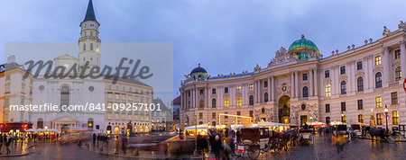 Christmas Market stalls and St. Michael Catholic Church in Michaelerplatz, Vienna, Austria, Europe