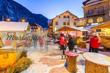 View of Christmas Market stalls at dusk in Campitello di Fassa, Val di Fassa, Trentino, Italy, Europe