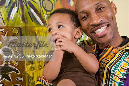 Portrait Of Happy African American Father Dressed In Traditional