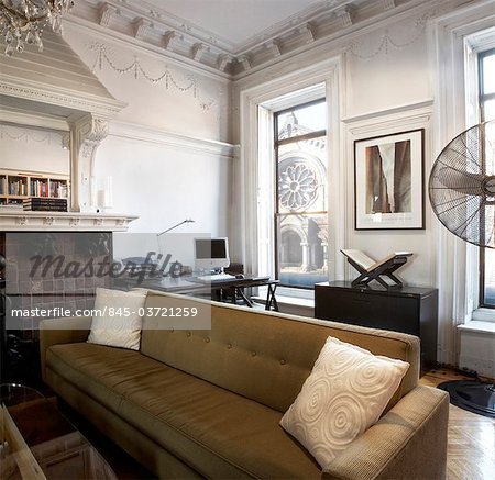 Brooklyn brownstone interior moulded ceiling, overmantel and large sofa. Architects: WE Design