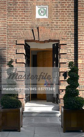 Front door of house in Chelsea, London with spiral topiary in planters. Architects: Chris Dyson Architects