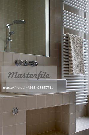 heated radiator and washbasin with mirror, Greencroft Gardens Apartment, London, UK. Architects: Openstudio