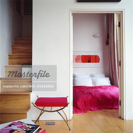 View through open doorway to double bed in modern bedroom