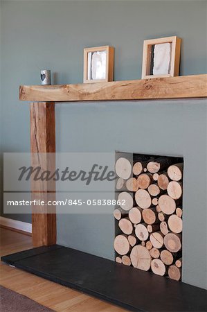 Modern fireplace with logs stored in recess