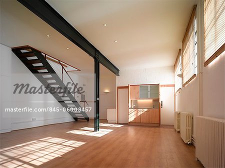 Empty Office Space With Exposed Steel Beams And Staircase Stock