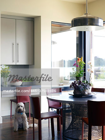 Chairs at round table in dining room of USA home