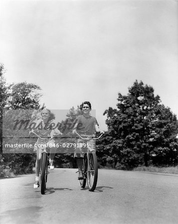1940s BOY GIRL RIDING BIKES DOWN COUNTRY LANE