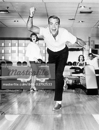 1960s 1950s SMILING MAN SHOWING GOOD FORM IN BOWLING ALLEY - Stock