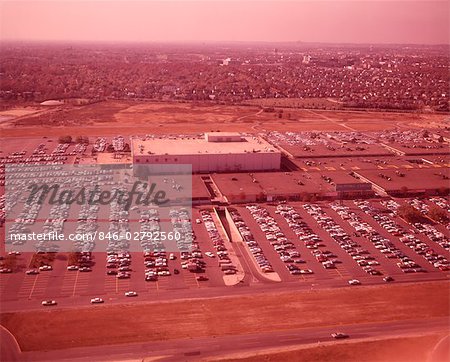 1960s AERIAL VIEW SUBURBAN SHOPPING MALL AND PARKING LOT