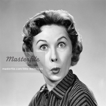 1950s WOMAN MAKING FUNNY FACE EYES WIDE LIPS PURSED AS IN A KISS OR A WHISTLE