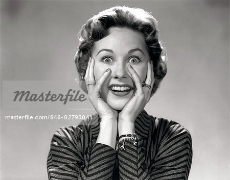 1950s 1960s PORTRAIT OF WACKY WOMAN HANDS ON FACE WITH SMILING EXCITED HAPPY FUNNY FACE SURPRISED EXPRESSION LOOKING AT CAMERA