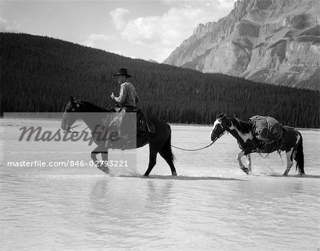 1940s COWBOY ON HORSEBACK CROSSING RIVER WITH 2ND HORSE IN TOW