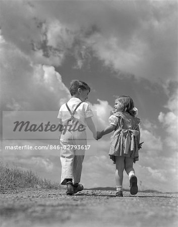1940s Boy Girl Holding Hands Walking Up Hill Into Bright Sky Full Of Clouds Stock Photo Masterfile Rights Managed Artist Classicstock Code 846