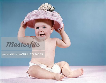 1960s BABY GIRL WEARING FISHING HAT HOLDING NET AND REEL FISHING