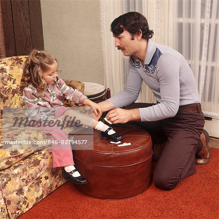 FATHER HELPING DAUGHTER WITH A CUT ON KNEE