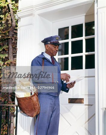 1960s African American Man Usps Mailman Carrying Mailbag Sorting