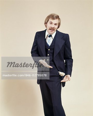 1970s UPSET BUSINESS MAN WITH EMPTY SUIT POCKET