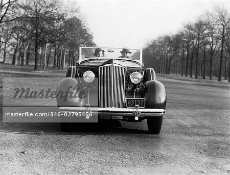 1930s 1935 COUPLE MAN AND WOMAN DRIVING PACKARD CONVERTIBLE AUTOMOBILE