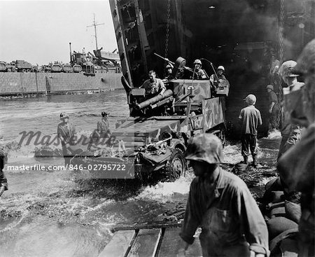 1940s MARINES EMERGE FROM NAVAL LANDING CRAFT ON A HALF TRACK VEHICLE ARMED WITH GUNS SOLDIERS WAR INVASION WEAPON MILITARY WWII