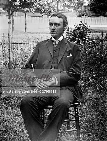 1890s 1900s TURN OF THE CENTURY PORTRAIT OF MAN IN THREE-PIECE SUIT SEATED IN CHAIR OUTSIDE