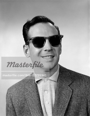 1950s 1960s PORTRAIT OF SMILING BLIND MAN WEARING SPORTS JACKET SHIRT AND VERY DARK PROTECTIVE SUNGLASSES