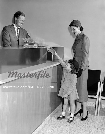 1950s MAN TELLER NEW ACCOUNTS IN BANK MOTHER WOMAN WITH LITTLE GIRL DAUGHTER HANDS PASSBOOK