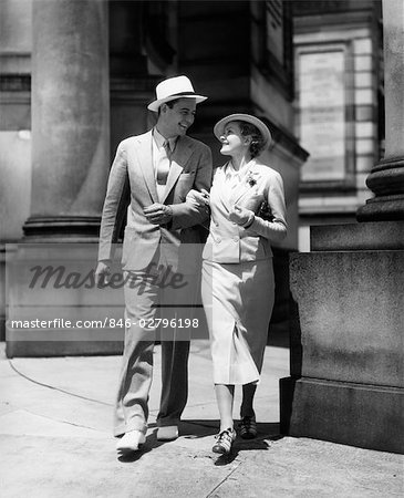 1930s Couple In Suits And Hats Walking Arm In Arm Stock Photo Masterfile Rights Managed Artist Classicstock Code 846 02796198