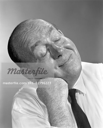 1950s 1960s BALDING MAN LEANING HEAD ON FIST IN SHIRT AND TIE EYES CLOSED SMILING THINKING EXPRESSION