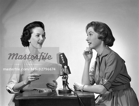 1950s TWO WOMEN DOING RADIO BROADCAST INDOOR