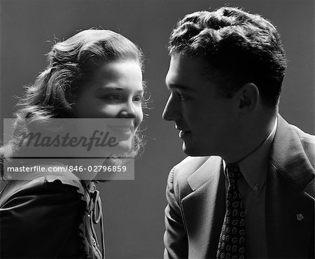 1940s SMILING COUPLE WITH THE KEY LIGHT ON THE WOMAN'S FACE & THE MAN IN SHADOW DRAMATIC ROMANTIC