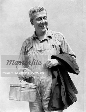 https://image1.masterfile.com/getImage/846-02797289em-1930s-man-in-overalls-work-uniform-holding-thermos-lunchbox-and.jpg