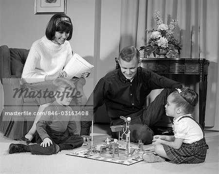 1960s FAMILY CHILDREN PLAYING GAME IN LIVING ROOM MOUSETRAP