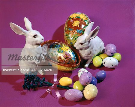 1960s 1970s EASTER RABBIT FIGURINES AND CANDY MALTED EGGS ON A BRIGHT PURPLE BACKDROP
