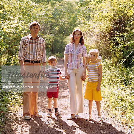 1970s FAMILY WALKING OUTDOORS FULL LENGTH MOTHER FATHER TWO KIDS MAN WOMAN BOY GIRL SUMMER