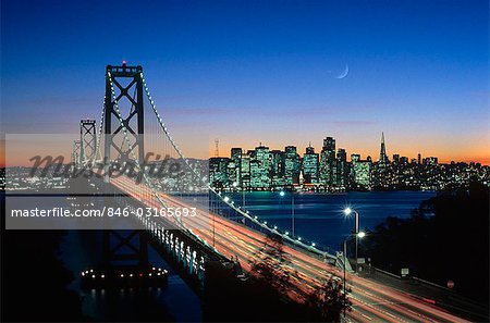 1980s SAN FRANCISCO AND OAKLAND BAY BRIDGE AT NIGHT SAN FRANCISCO, CALIFORNIA