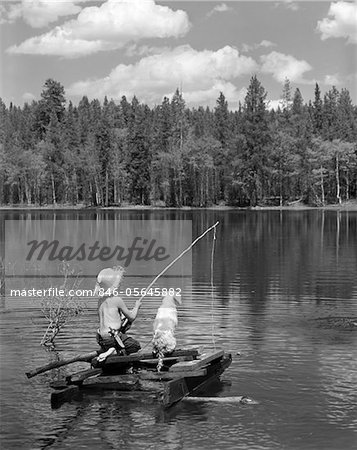 1950s BOY HUCK FINN STYLE ON HOMEMADE RAFT WITH DOG FISHING IN LAKE