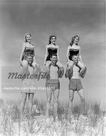 Having fun in the 1930s. Three young women on the beach dressed in