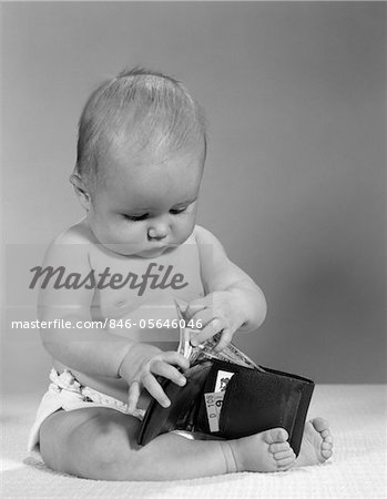 1960s BABY SITTING WEARING DIAPER TAKING PAPER MONEY OUT OF A WALLET